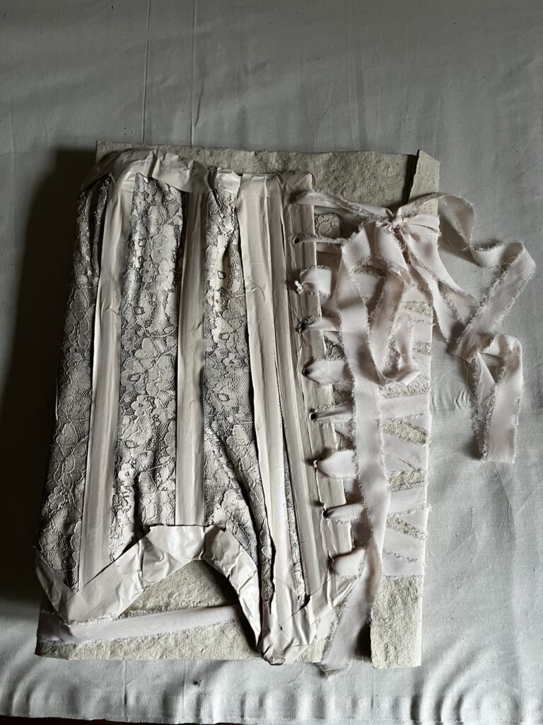 cover for bookwork made from upcycled corset